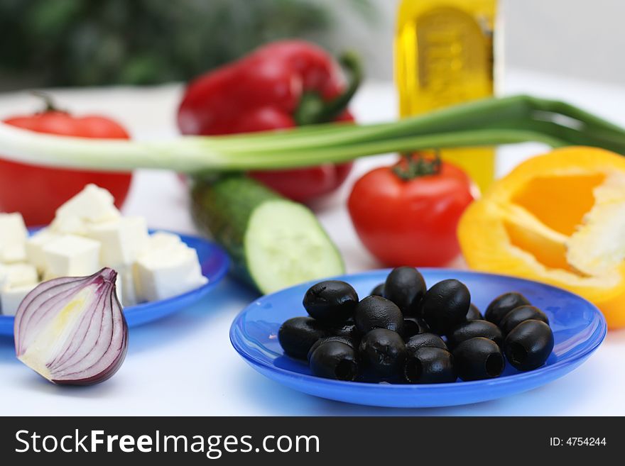 Multi-coloured vegetables for salad on a white background