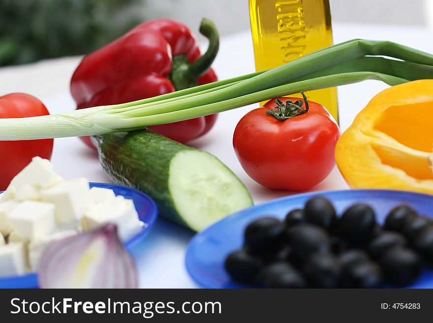 Multi-coloured vegetables for salad on a white background