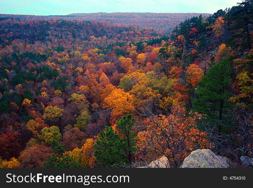Looking across a colorful autumn valley to bluffs on the other side. Looking across a colorful autumn valley to bluffs on the other side