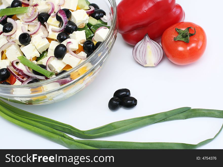 Multi-coloured vegetables for salad on a white background