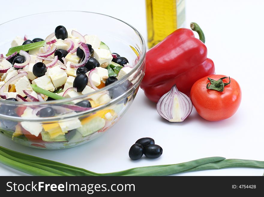 Multi-coloured vegetables for salad on a white background