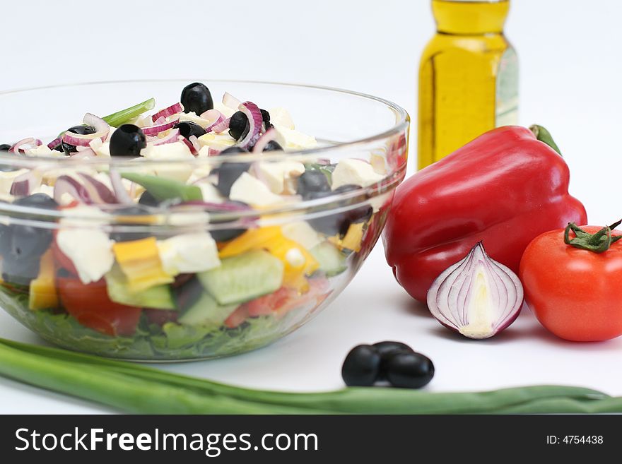 Multi-coloured vegetables for salad on a white background