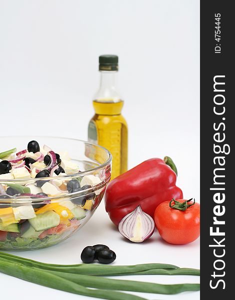 Multi-coloured vegetables for salad on a white background