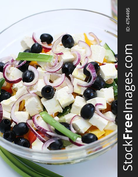 Multi-coloured vegetables for salad on a white background