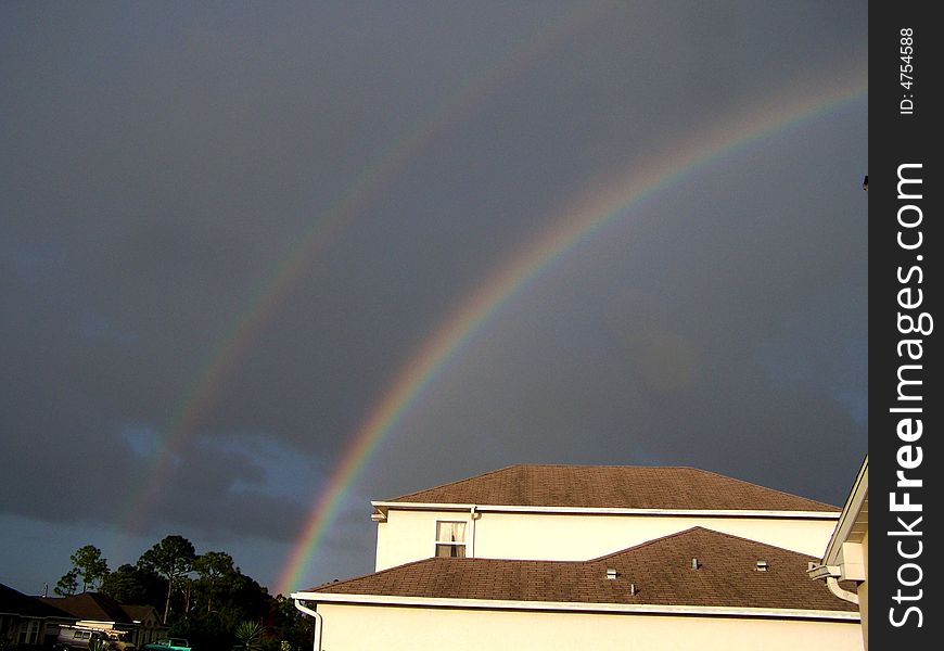 Double rainbow over house in St. Lucie County, Florida as the rain begins