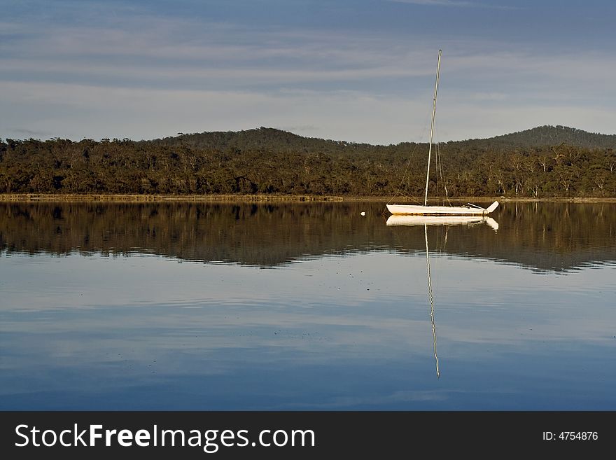 Lonely yacht reflected in the water