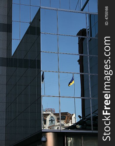 Reflection of ukrainian flag in the facade of modern building