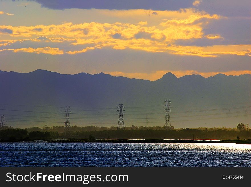 Before sunset the lake color change light blue,  the telegraph pole suddenly appeared. Before sunset the lake color change light blue,  the telegraph pole suddenly appeared