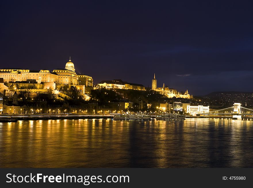 Budapest at night, th e Royal palace, behind the Matthias church and the Chainbridge