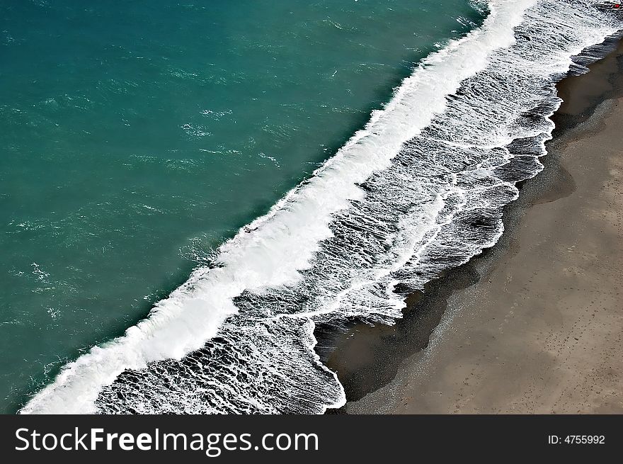 Waves rushing to the seashore taken seventy meters above