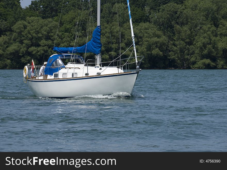 A white-hulled Canadian boat motoring on the Niagara river at the height of summer. A white-hulled Canadian boat motoring on the Niagara river at the height of summer.