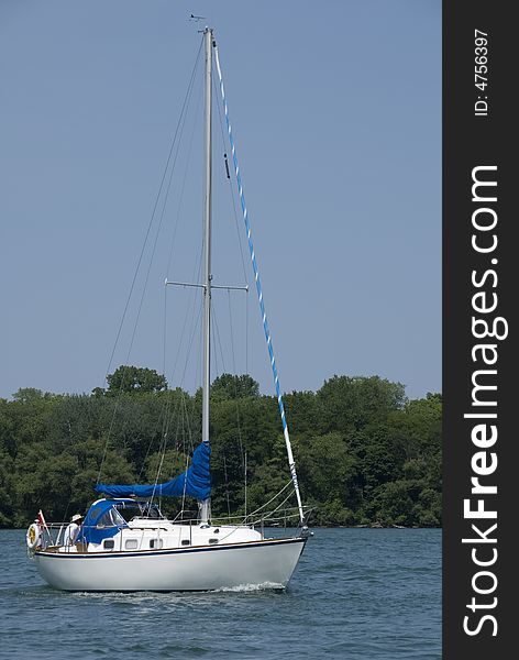 A white-hulled Canadian boat motoring on the Niagara river at the height of summer. A white-hulled Canadian boat motoring on the Niagara river at the height of summer.