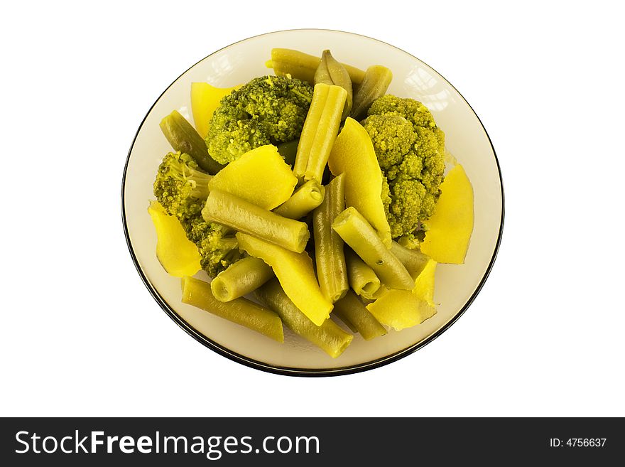 Steamed string beans, vegetable marrow and broccoli on a plate, isolated. Steamed string beans, vegetable marrow and broccoli on a plate, isolated