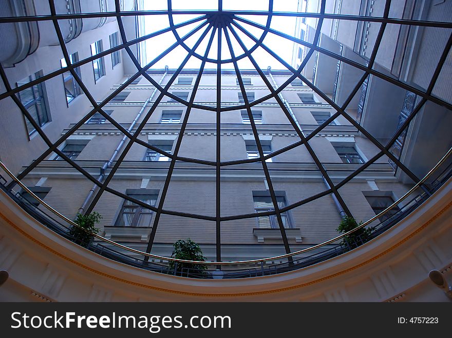 Atrium.Type of building through the glass round ceiling in a hotel. Atrium.Type of building through the glass round ceiling in a hotel
