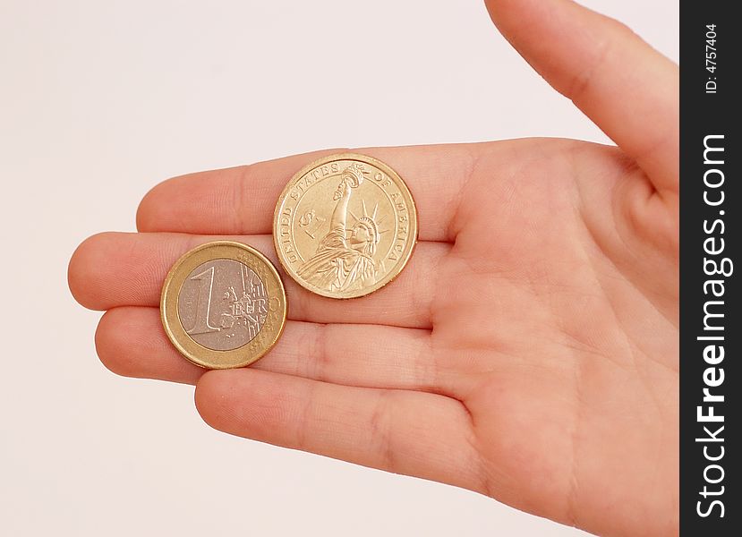 Womans hand , holding euro and dollar coins