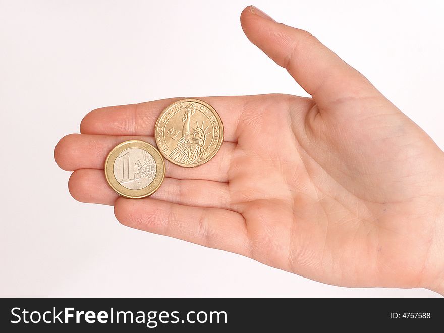 Womans hand , holding euro and dollar coins