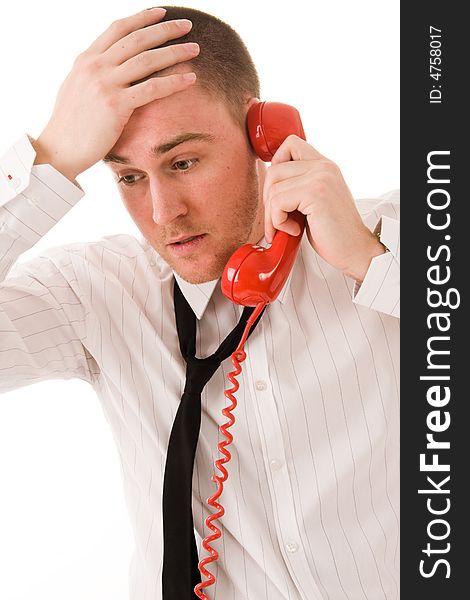 Young handsome businessman and red telephone receiver