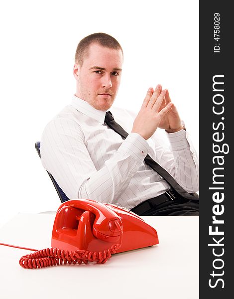 Young handsome businessman and red telephone