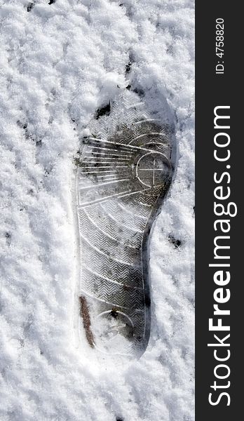 A footprint in the snow. A footprint in the snow