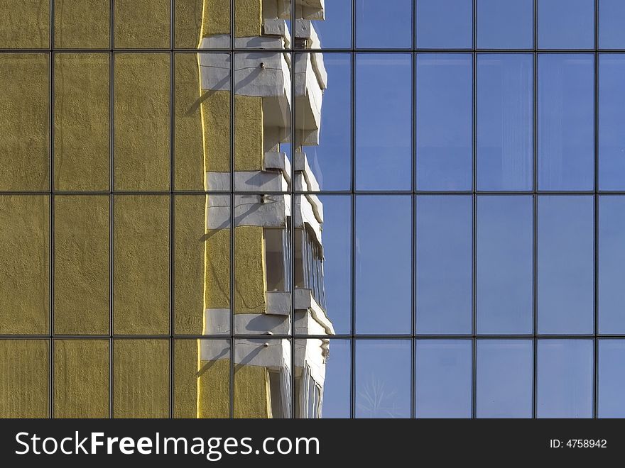 Reflexion of the old, yellow building in the glass wall of modern office park skyscraper. Reflexion of the old, yellow building in the glass wall of modern office park skyscraper.