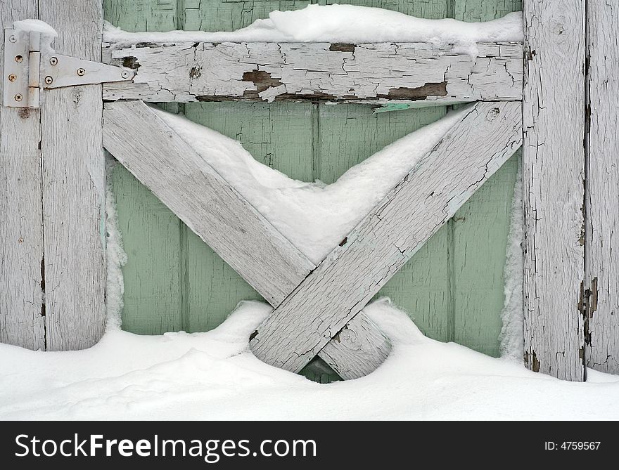 Snow drifted against part of an old door. Snow drifted against part of an old door