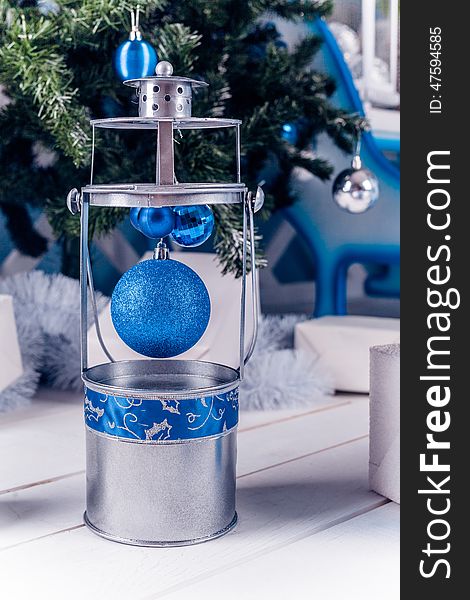 Christmas lantern on white wooden floor with blue Christmas ball