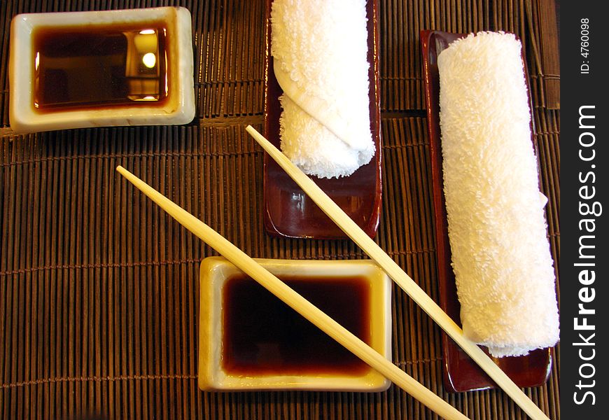 Sushi table sticks sauce white towels. Sushi table sticks sauce white towels