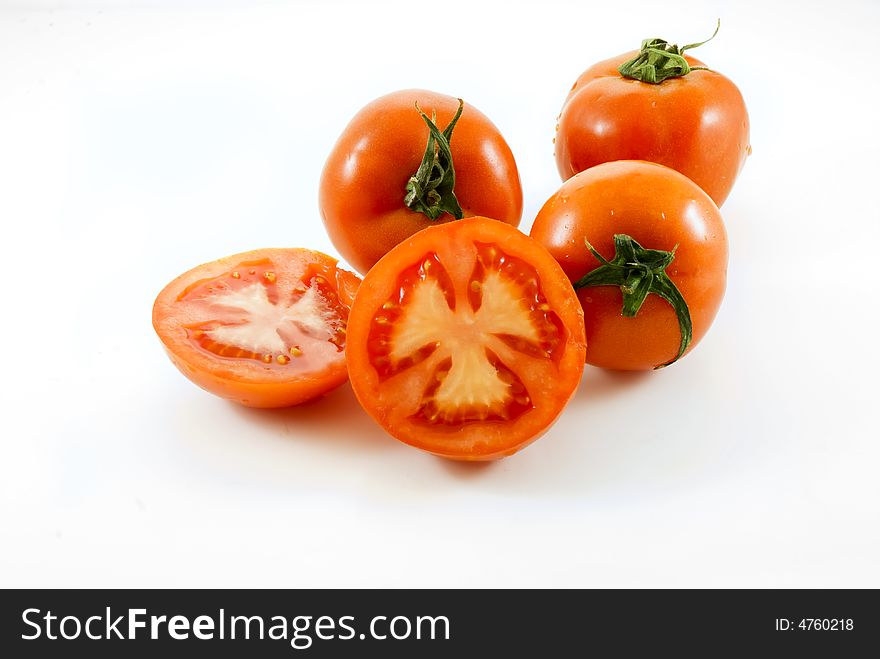 Red Tomatoes and slice on white background