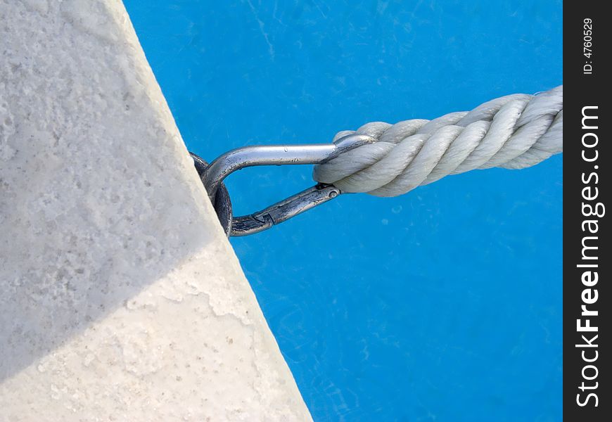 Detail of a rope and hook in the border of the pool