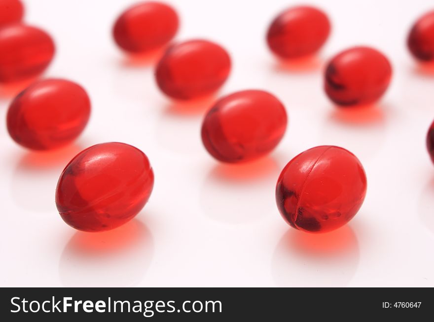 Red capsules on white background