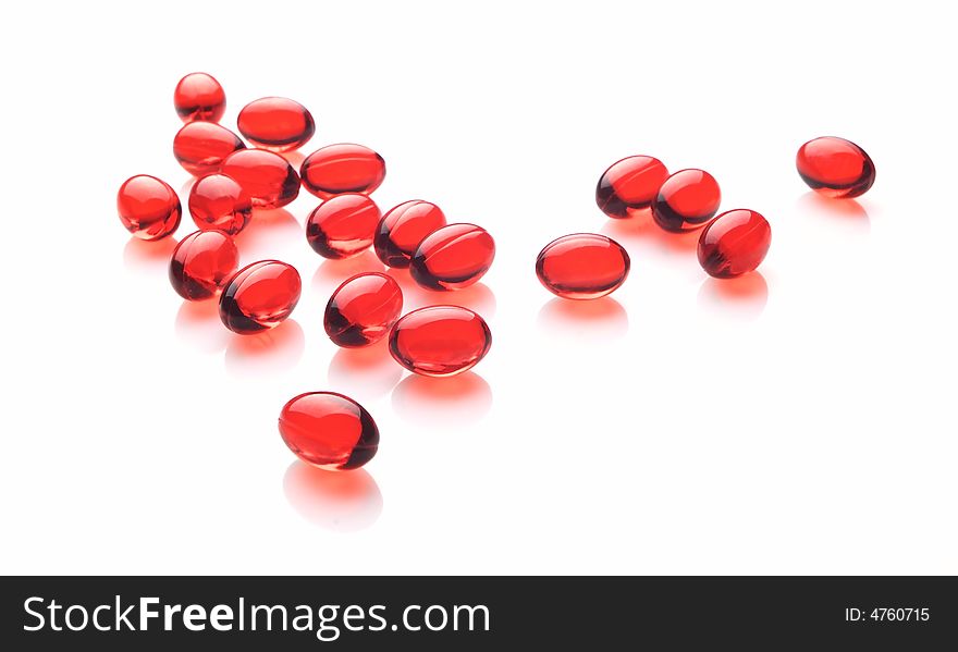 Red capsules on white background