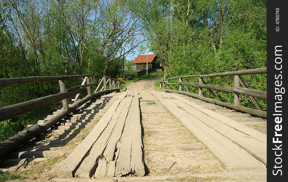 The old wooden bridge in village. The old wooden bridge in village