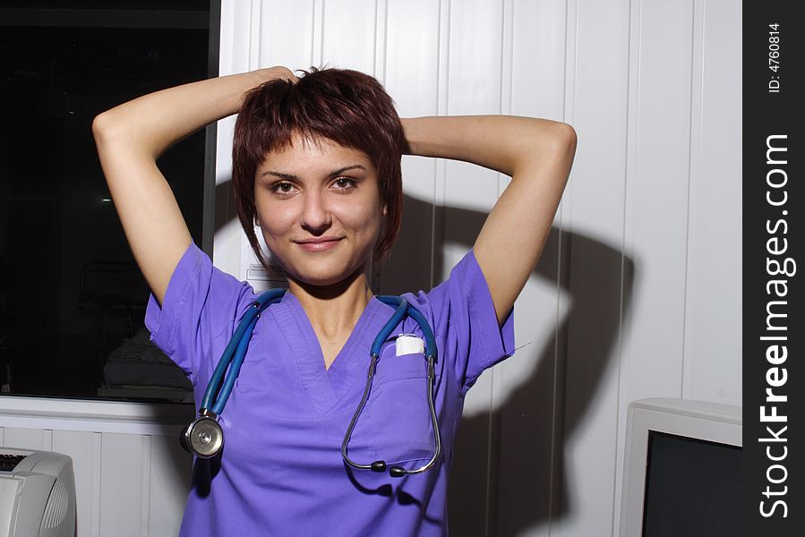 Young doctor sits with stethoscope and smiles. Young doctor sits with stethoscope and smiles