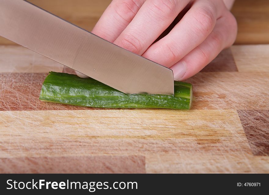 Cutting the cucumber with a kitchen knife