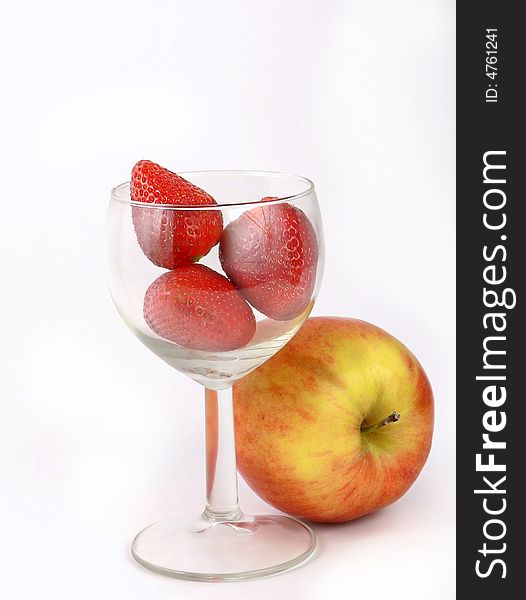 Strawberry in a wine glass and apple. Strawberry in a wine glass and apple