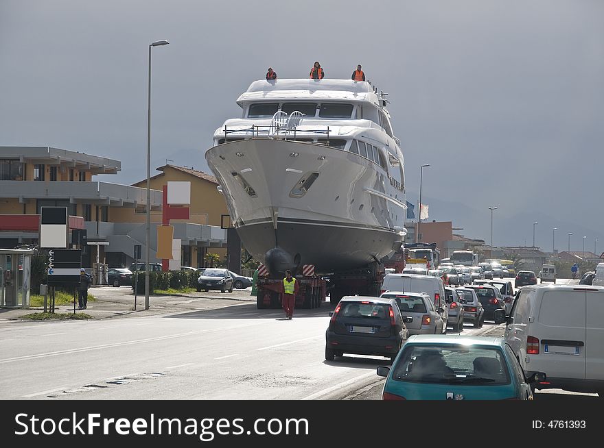 Big yacht transported on a special truck on the road. Big yacht transported on a special truck on the road