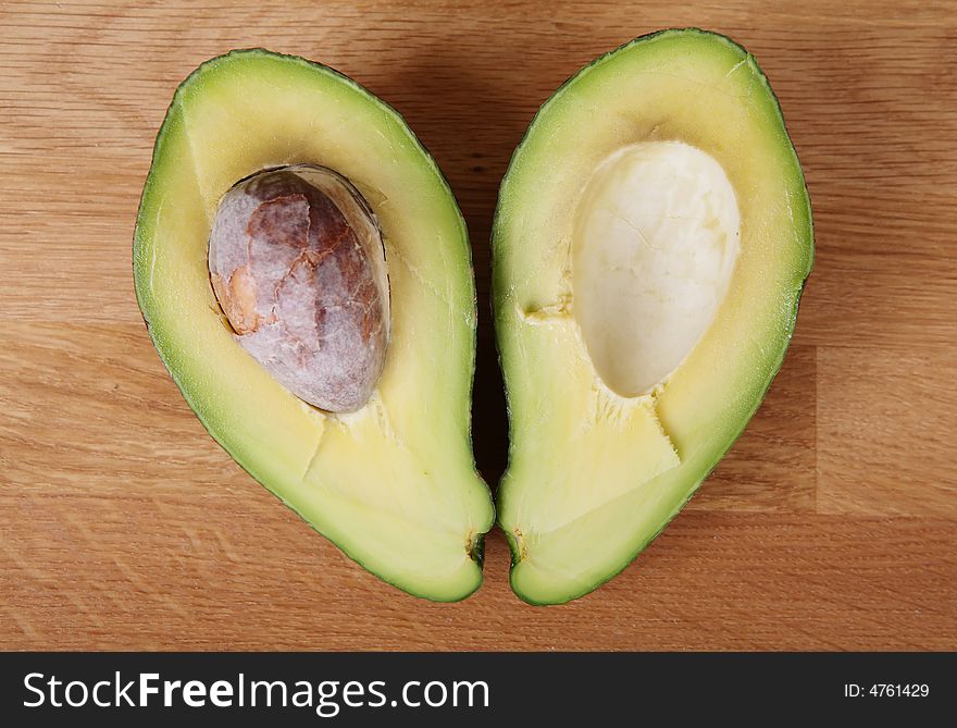 Two halves of avocado making heart shape. Focus point on fruit (not the stone). Two halves of avocado making heart shape. Focus point on fruit (not the stone).