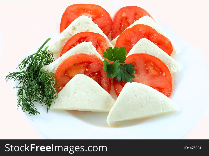 Tomato and slice on white background
