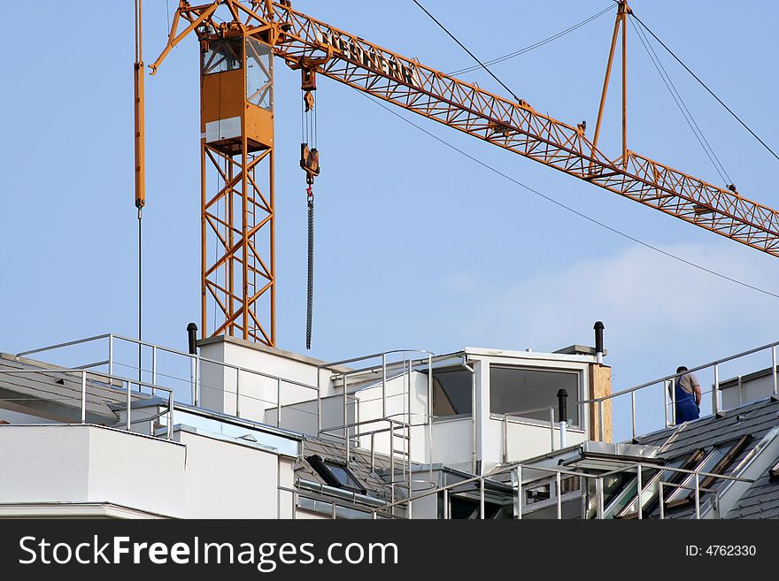 House renovations with a crane, sky background.