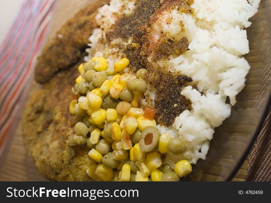 Delicious baked chicken with white rice, corn and pea