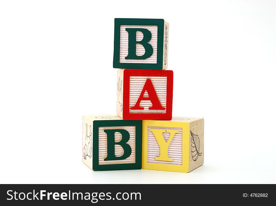 Word baby formed by alphabet wood blocks on a white surface