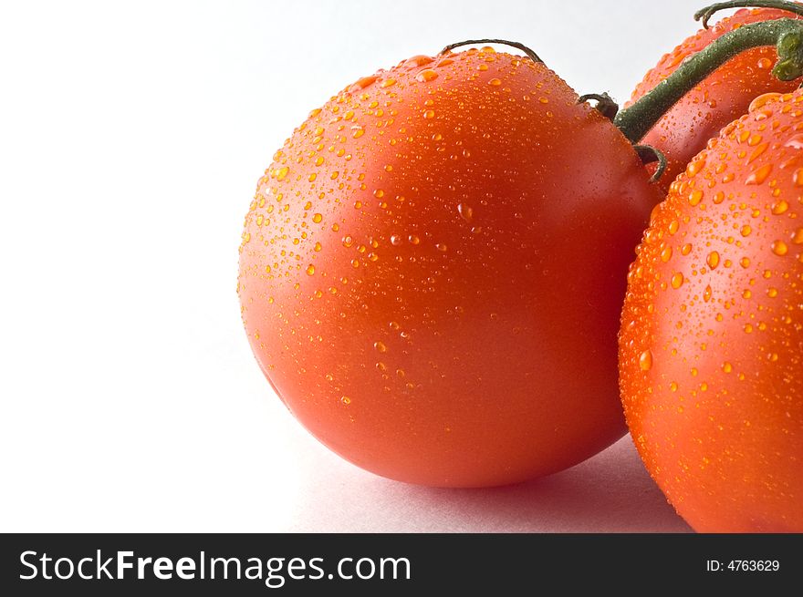 Vine ripened tomatoes against white, close up on one. Vine ripened tomatoes against white, close up on one.