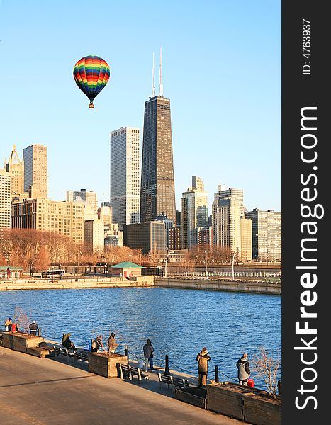 Hot air balloon flies above high-rise buildings in downtown Chicago. Hot air balloon flies above high-rise buildings in downtown Chicago.