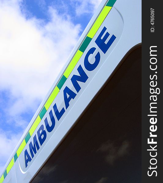 Close-up of ambulance sign against cloudy sky. Close-up of ambulance sign against cloudy sky