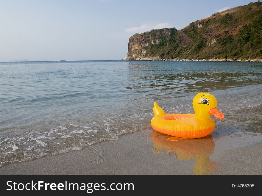 Yellow duck by the beach. Yellow duck by the beach