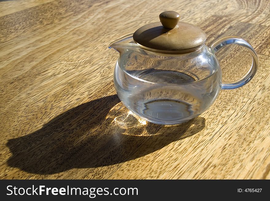 Transparent cup with water on a wooden floor. Transparent cup with water on a wooden floor.