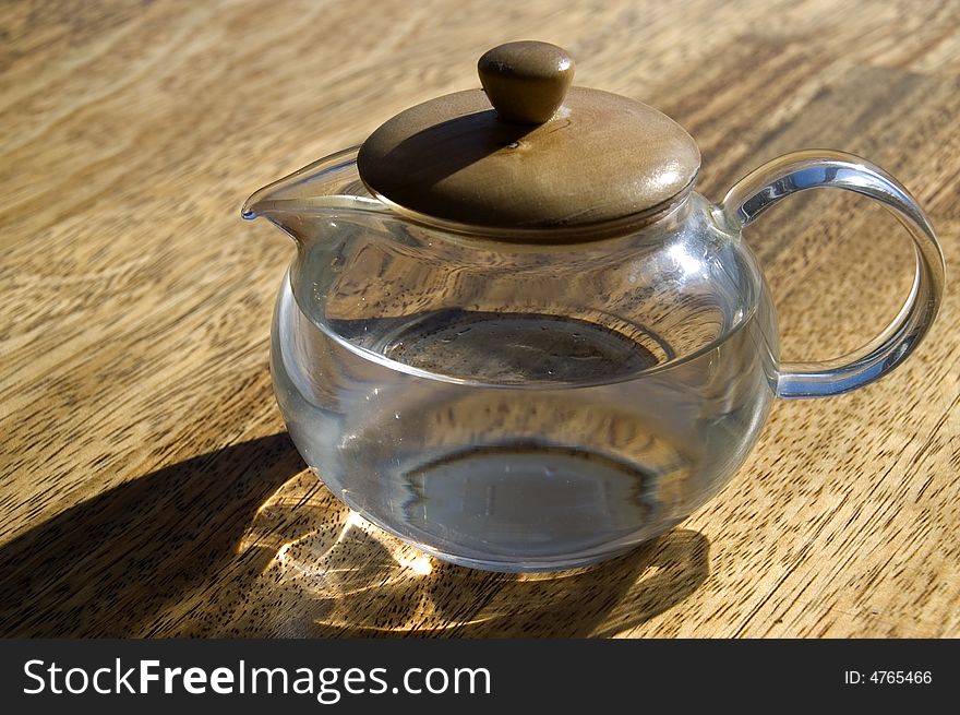 Transparent cup with water on a wooden floor. Transparent cup with water on a wooden floor.