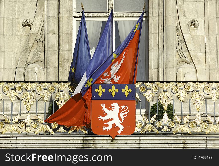 France; Lyon or Lyons: view of the facade of the town hall with his statues and carved halls ; the most popluar is the statue of the king Henri 4th. the construction is from the 16th century; in the image the french and the city flags together with the city coat arms, the lion, at the window of the city hall. France; Lyon or Lyons: view of the facade of the town hall with his statues and carved halls ; the most popluar is the statue of the king Henri 4th. the construction is from the 16th century; in the image the french and the city flags together with the city coat arms, the lion, at the window of the city hall