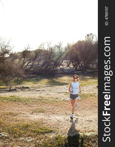 A woman running down a path at the beach