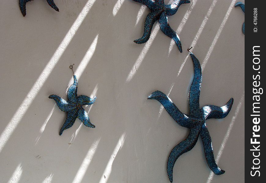 Metal Starfish on a wall with sunlight